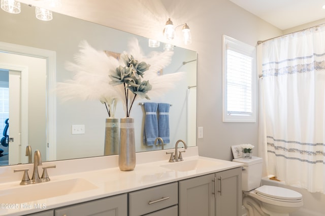 full bathroom with shower / bath combo, a sink, toilet, and double vanity