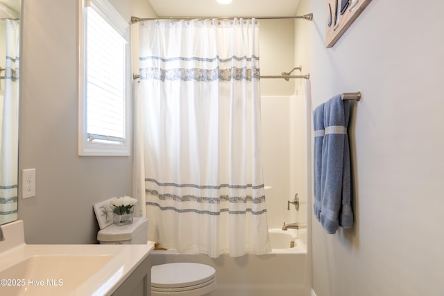 bathroom featuring toilet, vanity, and shower / tub combo with curtain