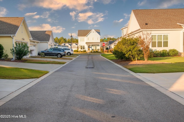 view of road with traffic signs and a residential view