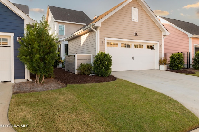 view of property exterior featuring a garage, a lawn, and concrete driveway