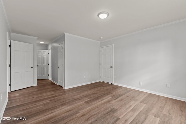 unfurnished room with hardwood / wood-style flooring and ornamental molding