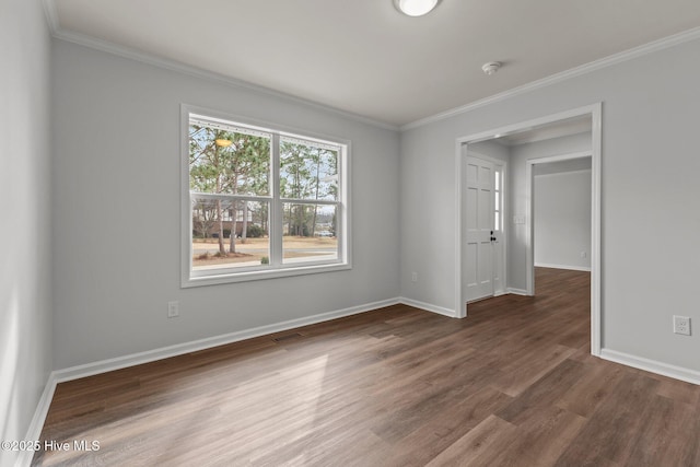 spare room with dark hardwood / wood-style flooring and ornamental molding