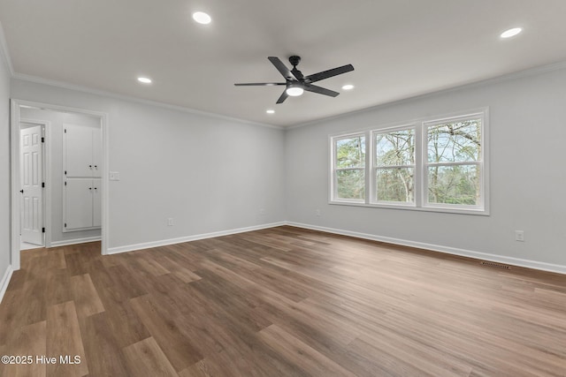 unfurnished room featuring ceiling fan, hardwood / wood-style floors, and crown molding