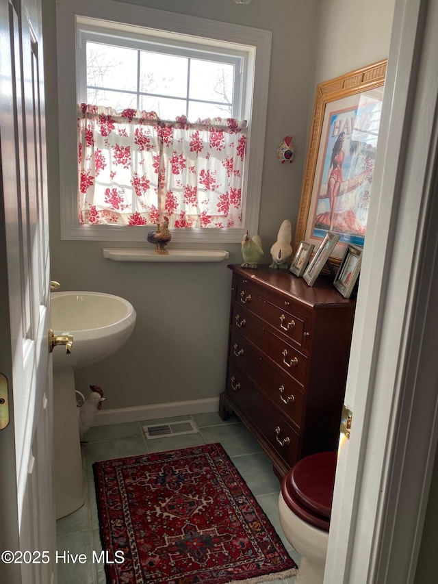 bathroom featuring tile patterned flooring and toilet