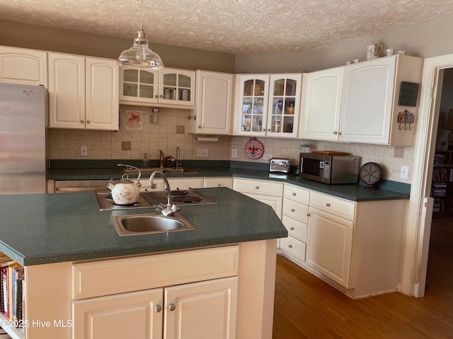 kitchen with decorative backsplash, sink, appliances with stainless steel finishes, and dark wood-type flooring