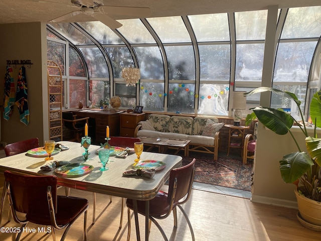 sunroom / solarium featuring ceiling fan