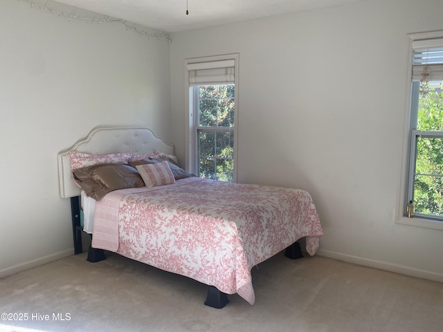 carpeted bedroom featuring multiple windows