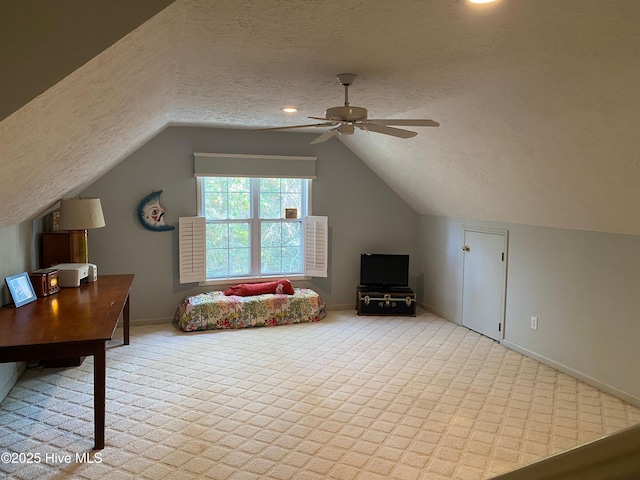 additional living space featuring ceiling fan, light colored carpet, a textured ceiling, and vaulted ceiling