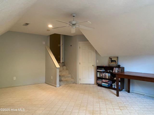 additional living space featuring ceiling fan, a textured ceiling, and vaulted ceiling