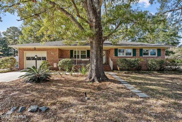 ranch-style house with a porch and a garage