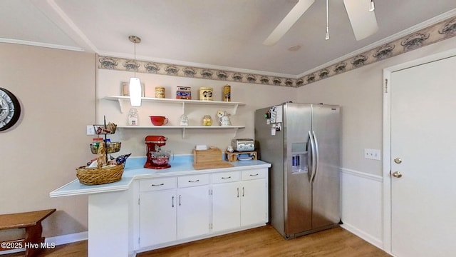 kitchen with white cabinetry, ceiling fan, hanging light fixtures, light hardwood / wood-style flooring, and stainless steel fridge