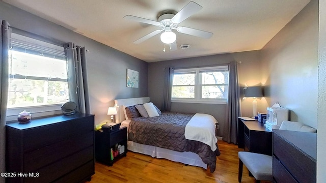 bedroom with wood-type flooring and ceiling fan