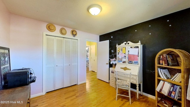 home office with light hardwood / wood-style floors