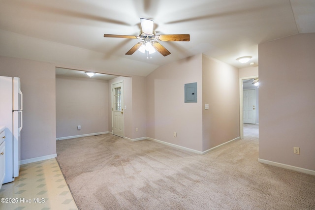 interior space with electric panel, ceiling fan, light colored carpet, and vaulted ceiling