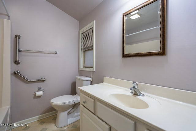 bathroom with vanity, toilet, and lofted ceiling