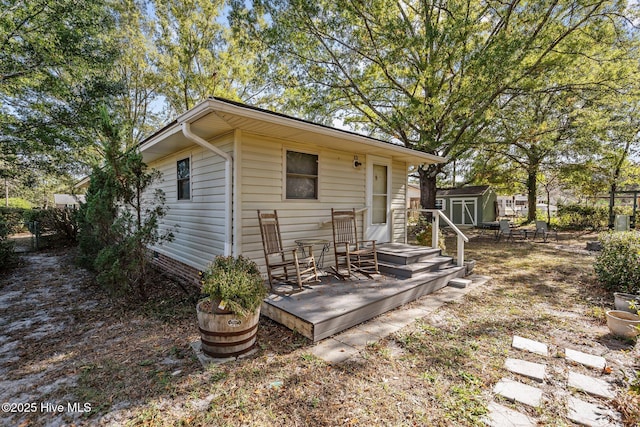 back of house featuring a storage unit