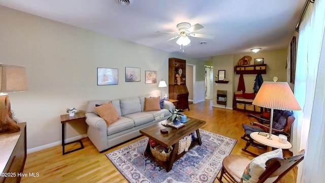 living room featuring ceiling fan and light hardwood / wood-style floors