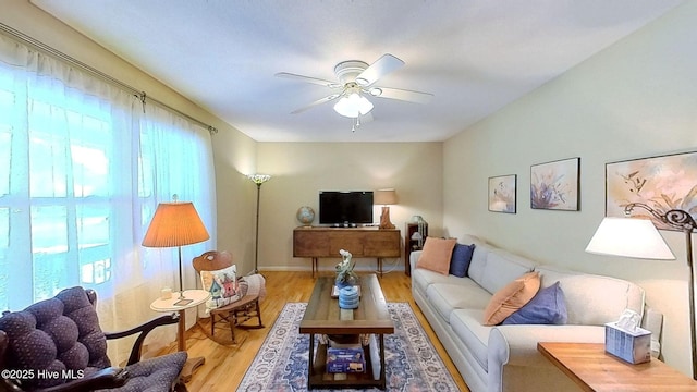 living room with hardwood / wood-style floors and ceiling fan