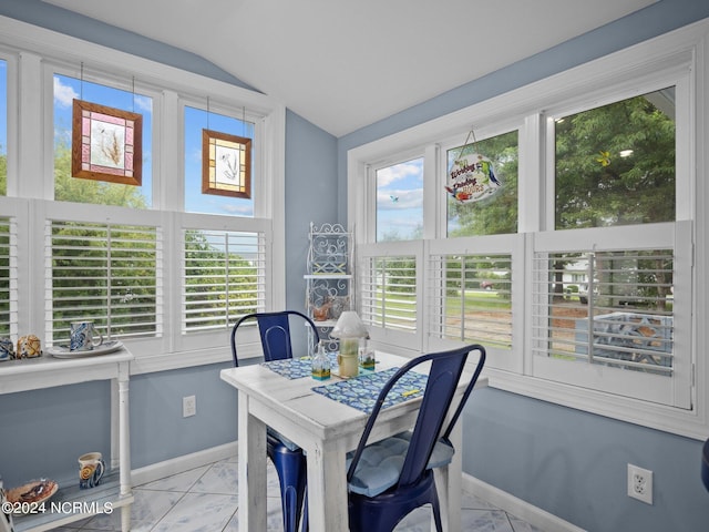 sunroom / solarium featuring lofted ceiling