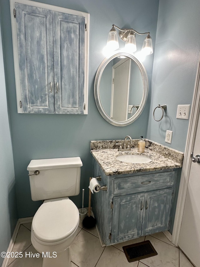 bathroom with tile patterned floors, vanity, and toilet