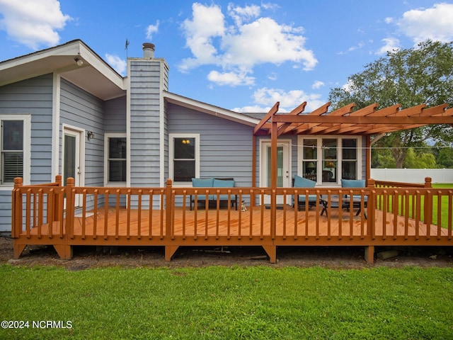 rear view of house with a yard, a pergola, and a wooden deck