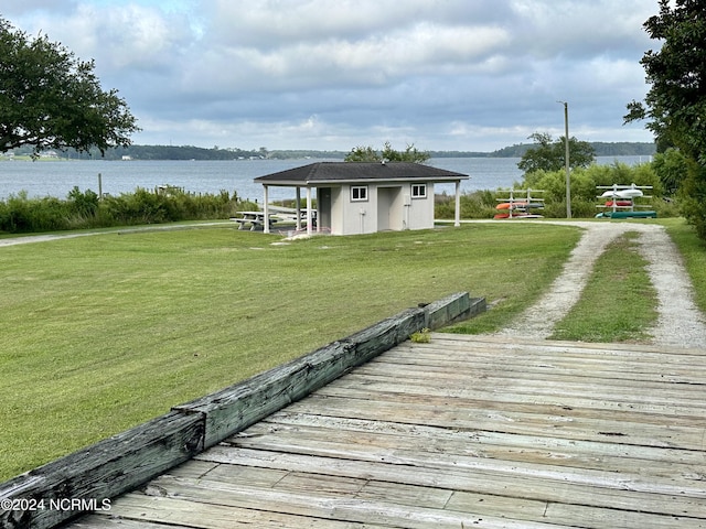 view of dock featuring a water view and a yard