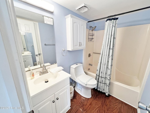 bathroom featuring toilet, wood finished floors, vanity, and shower / bathtub combination with curtain