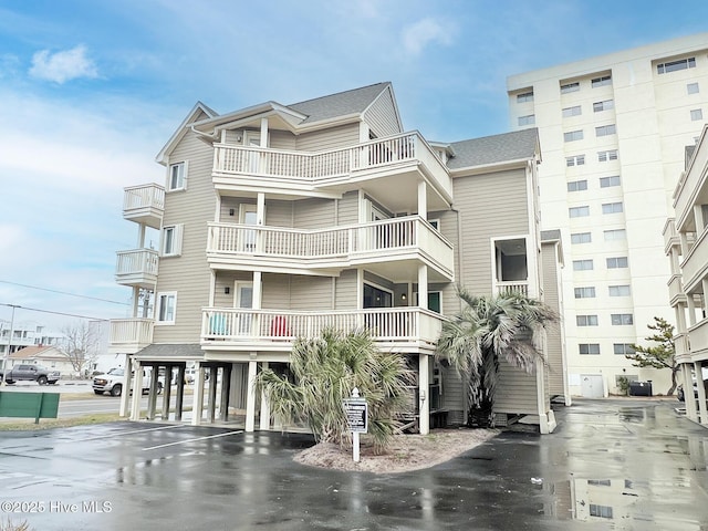 view of property with driveway and a carport