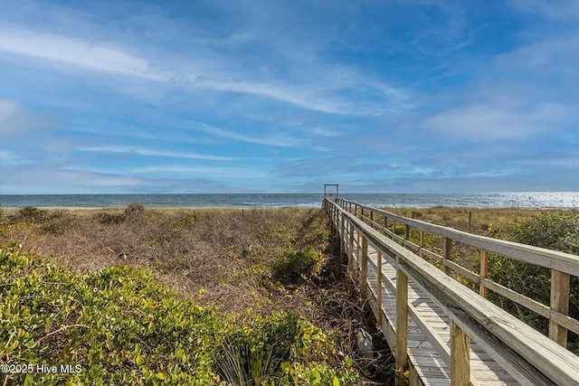 view of home's community featuring a beach view and a water view