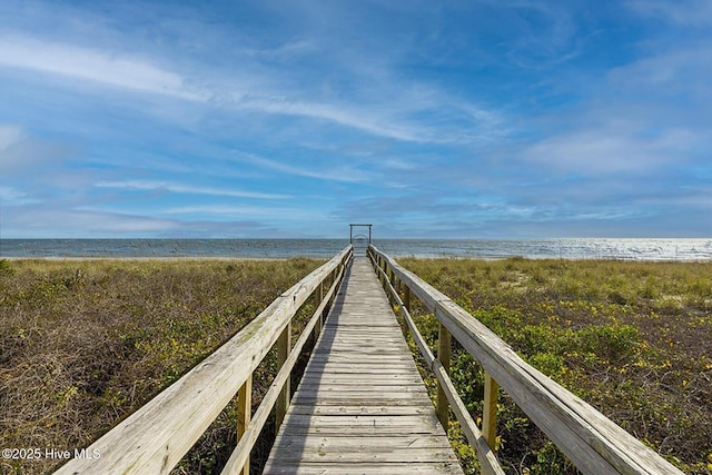 surrounding community with a water view and a view of the beach