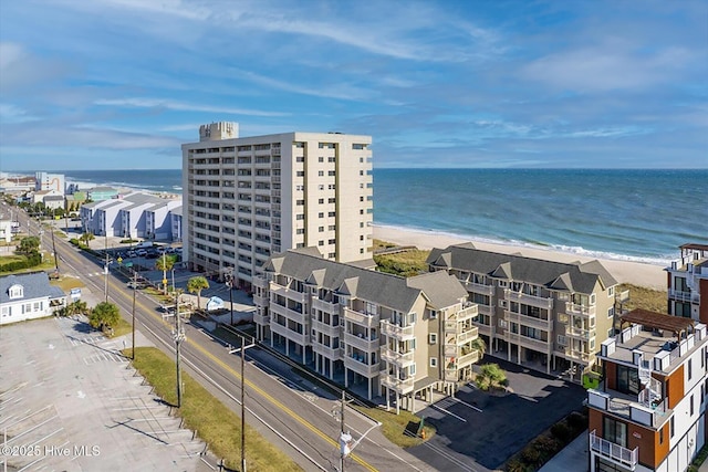 drone / aerial view featuring a beach view and a water view