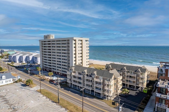 birds eye view of property featuring a water view and a view of the beach