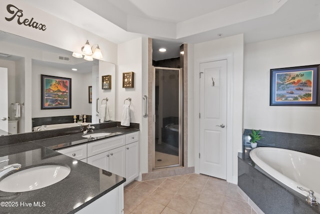 bathroom with tile patterned flooring, vanity, a raised ceiling, and plus walk in shower