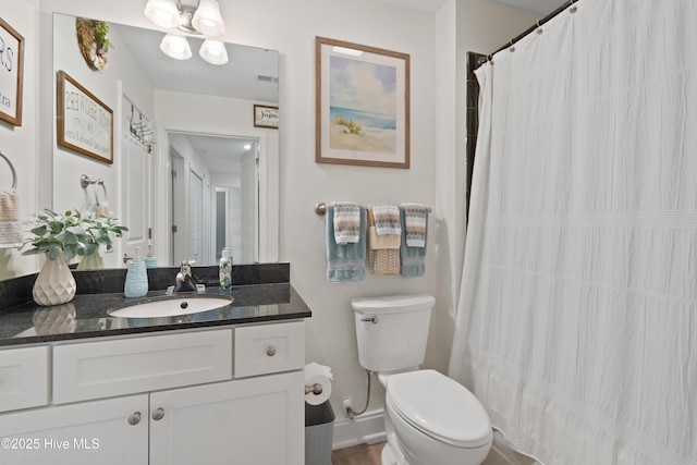 bathroom featuring vanity and toilet