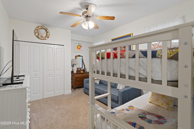 carpeted bedroom with a closet and ceiling fan