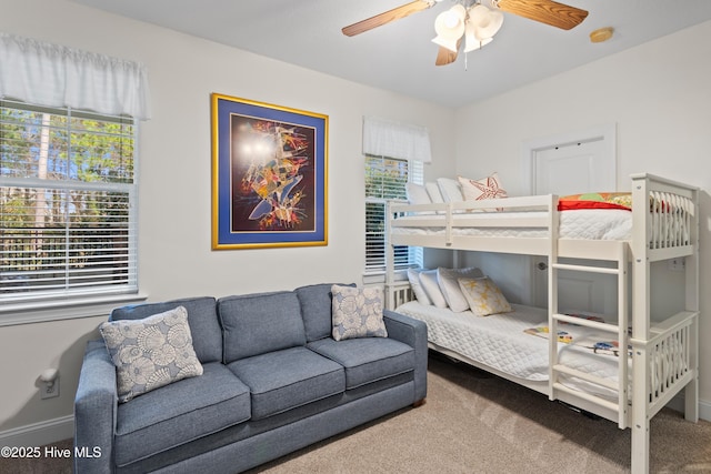 bedroom with multiple windows, carpet floors, and ceiling fan