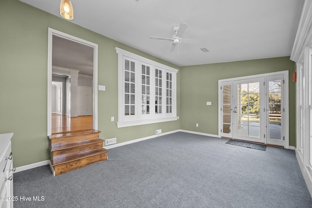 interior space with ceiling fan, lofted ceiling, and dark colored carpet