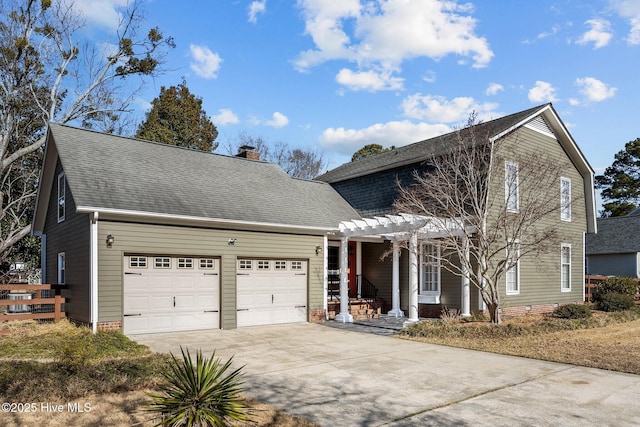 view of property with a garage and a pergola