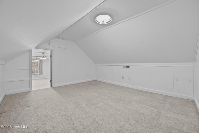 bonus room featuring lofted ceiling and light carpet