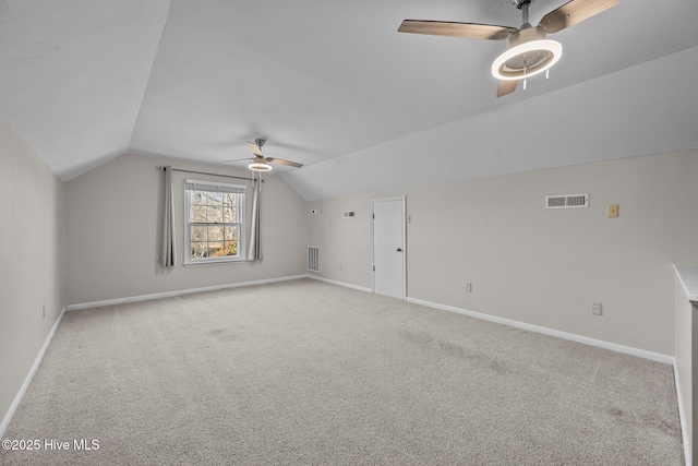 additional living space with lofted ceiling, light colored carpet, and ceiling fan