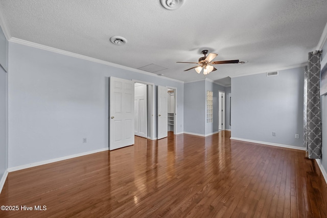 empty room with ceiling fan, wood-type flooring, ornamental molding, and a textured ceiling