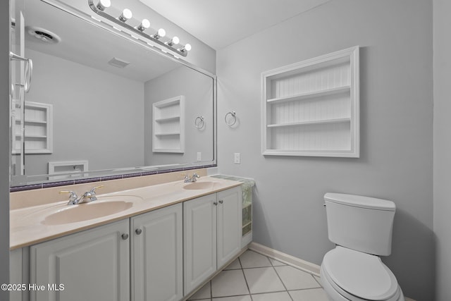 bathroom with toilet, tile patterned floors, and vanity