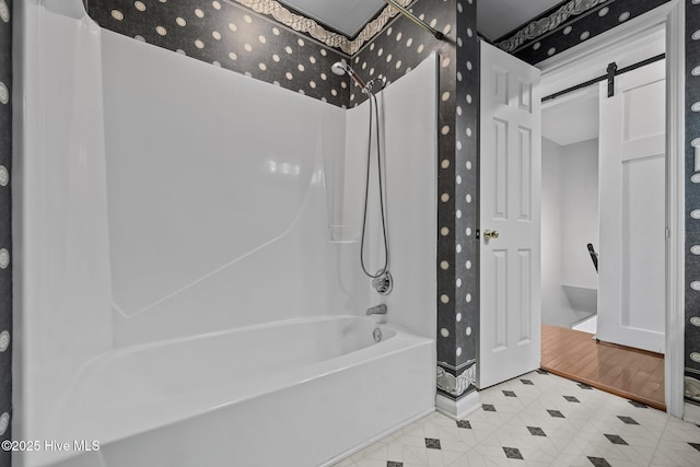 bathroom with bathtub / shower combination and hardwood / wood-style floors