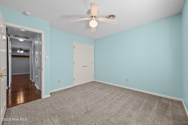 unfurnished bedroom with ceiling fan and carpet flooring