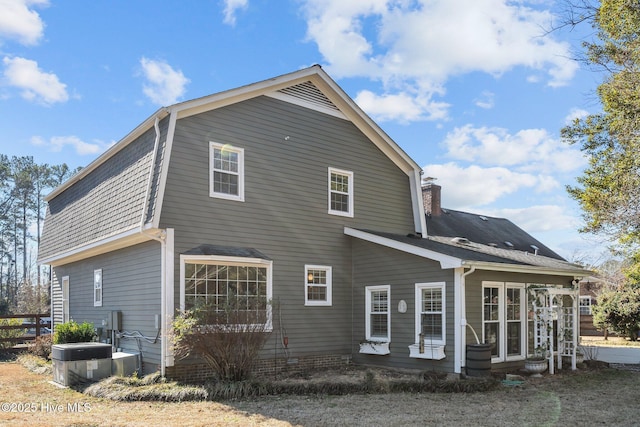 rear view of property featuring central AC unit