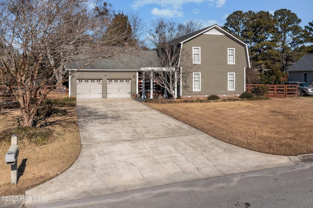 view of property with a front yard and a garage