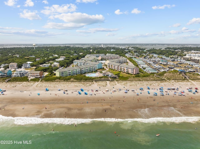 birds eye view of property with a view of the beach and a water view