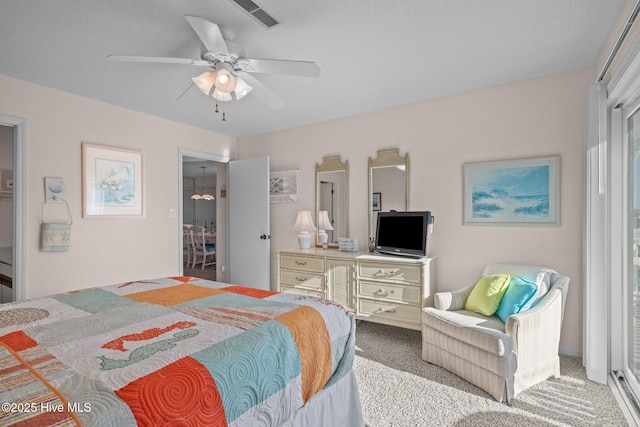 bedroom featuring light carpet, a textured ceiling, and ceiling fan