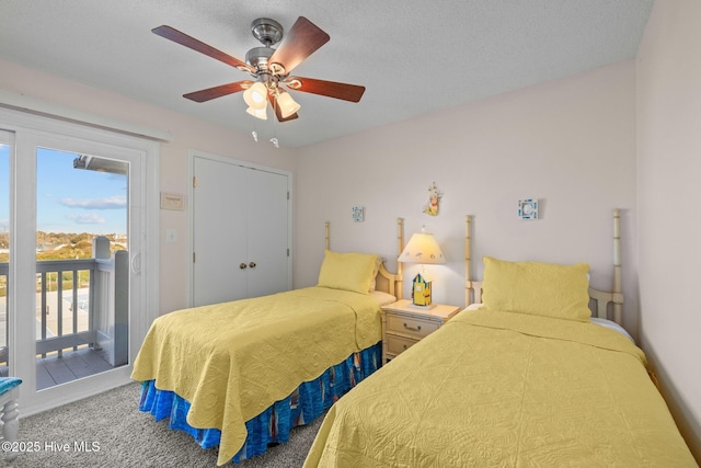 bedroom featuring carpet flooring, a textured ceiling, access to outside, ceiling fan, and a closet