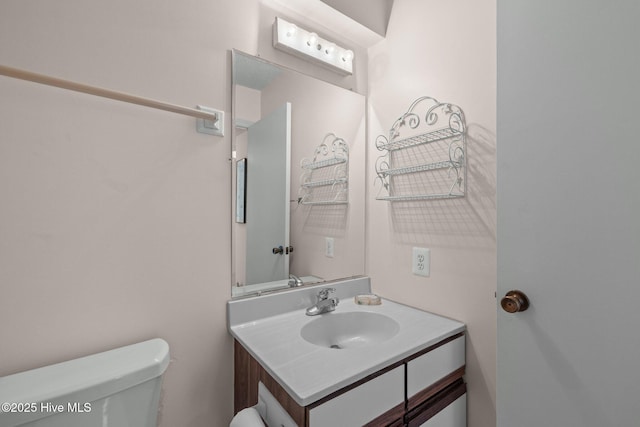 bathroom featuring vanity and toilet